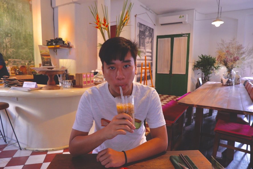 Khoa Phan sipping coffee